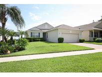Well-manicured lawn and landscaping complement this home's charming exterior at 2362 Prairie Dunes, Clermont, FL 34711