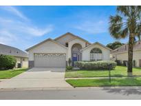 Charming single-story home with attached garage and well-manicured front lawn at 2515 La Jolla Trl, Kissimmee, FL 34747
