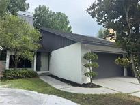 Charming two-story home featuring a well-manicured lawn and an attached two-car garage at 304 Spring Run Cir, Longwood, FL 32779