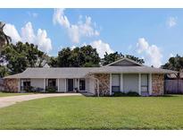 Charming single-story home boasts stone accents and a well-manicured front lawn at 4217 Ilene Ct, Orlando, FL 32806