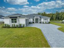 Stunning single-story home with manicured lawn and elegant stone accents at 4266 La Salle Ave, St Cloud, FL 34772