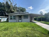 Cozy single-story home featuring a carport and a well-maintained front yard and walkway at 4631 America St, Orlando, FL 32811