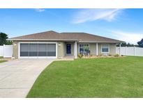 Charming single-story home features a well-maintained lawn, neutral exterior, and a driveway leading to the garage at 6011 Country Walk Ln, Winter Haven, FL 33880