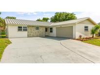 Well-maintained single-story home featuring a spacious driveway and attached garage at 955 Tomes Ct, Orlando, FL 32825