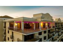 Elegant condominium featuring multiple balconies, large windows, and stylish architectural details at sunset at 111 E Monument Ave # 801, Kissimmee, FL 34741