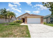Charming single-story home with a two-car garage and a well-manicured lawn in a lovely neighborhood at 11715 Sindlesham Ct, Orlando, FL 32837
