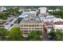 Stunning aerial view showcasing the building's architecture and surrounding city landscape with lush green trees at 140 E Morse Blvd # C, Winter Park, FL 32789