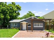 Charming home featuring a gray exterior, brick walkway, and pergola at 1921 Dartmouth Ave, Winter Park, FL 32789