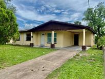 Charming one-story home features a welcoming front porch and a well-maintained lawn at 4394 Prince Hall Blvd, Orlando, FL 32811