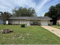 Charming single-story home features a well-maintained front yard, a driveway, and an attached one car garage at 6308 Stanwin Dr, Apopka, FL 32712