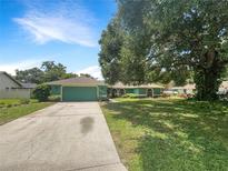 Charming single-story home with a large front yard and mature tree at 6740 Odoniel W Loop, Lakeland, FL 33809
