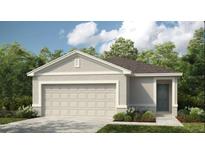 Charming single-story home with a two-car garage, manicured lawn, and neutral color palette at 7389 Capstone Dr, Groveland, FL 34736