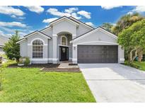 Charming single-Gathering home boasts meticulous landscaping and a two-car garage at 7809 Altavan Ave, Orlando, FL 32822