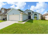 Charming single-story home featuring a two-car garage and well-manicured lawn at 7952 Oakstone Ct, Orlando, FL 32822