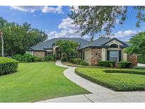 Charming single-story home boasts stone accents, lush landscaping, and a winding walkway to the front door at 1224 Northern Way, Winter Springs, FL 32708