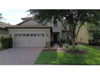 Charming home featuring a well-maintained front yard and a spacious two-car garage at 1452 Moon Valley Dr, Davenport, FL 33896
