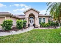 Charming single-Gathering home featuring a well-manicured lawn and a welcoming double door entrance at 14634 Astina Way, Orlando, FL 32837