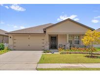 Charming single-story home with a two-car garage, and a well-manicured lawn at 1797 Sundance Chase Rd, Minneola, FL 34715