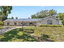 Charming single-story home with a well-manicured lawn and beautifully maintained landscaping at 2220 Derbyshire Rd, Maitland, FL 32751