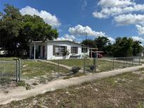 Charming single-story home with a fenced yard, mature trees, and covered porch at 2302 Greenwood St St, Deltona, FL 32738