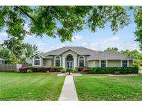 Charming single-story home boasts a well-manicured lawn and inviting curb appeal, perfect for families at 245 Meadow Bay Ct, Lake Mary, FL 32746
