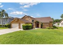 Charming two-story home with a well-manicured front yard, inviting entrance and two-car garage at 425 Sterling Lake Dr, Ocoee, FL 34761