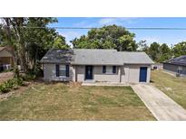 Charming single story home featuring a concrete driveway, tidy landscaping, and a neutral paint scheme at 1066 Swanson Dr, Deltona, FL 32738