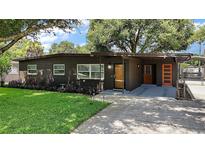 Charming home featuring a beautifully landscaped front yard and covered parking at 116 E Lauren Ct, Fern Park, FL 32730