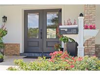 Charming home showcasing a stylish gray double front door with lovely mailbox and colorful landscaping at 1191 Banbury Trl, Maitland, FL 32751