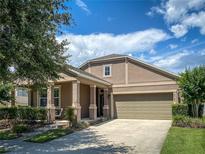 Beautiful single-Gathering home with a well-manicured lawn, a two-car garage, and a cozy front porch at 12795 Bosworth Ave, Windermere, FL 34786