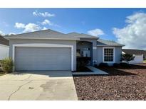 Charming single-Gathering home with a well-maintained lawn and two-car garage in a suburban neighborhood at 1354 Knollwood Dr, Davenport, FL 33837
