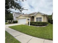 Charming single-story home featuring a two-car garage and well-manicured lawn at 1574 Derby Glen Dr, Orlando, FL 32837