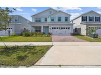 Charming two-story home with a well-manicured lawn and appealing curb appeal, showcasing a modern design at 2056 Airedale Way, Lake Alfred, FL 33850
