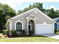 Charming single-story home with neutral paint, manicured lawn and attached two car garage at 2131 Kaylas Ct, Orlando, FL 32817