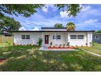 Charming home featuring a new modern design with updated landscaping and freshly cut grass at 226 Palmyra Dr, Orlando, FL 32807