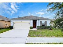 Charming single-story home with a well-manicured lawn, inviting curb appeal, and a one-car garage at 3354 Summerdale Way, Kissimmee, FL 34746