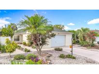 Charming single-story home with well-maintained landscaping, a two-car garage, and a welcoming entrance at 1008 Jackson St, The Villages, FL 32162