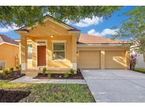 Charming single-story home featuring a two-car garage and well-manicured front yard at 10580 Moss Rose Way, Orlando, FL 32832