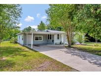 Charming single-story home with a covered carport and well-maintained front yard at 1310 Coletta Dr, Orlando, FL 32807