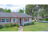 Charming single-story home with red trim, a well-manicured lawn, and a welcoming front entrance at 141 N Hill Ave # 141, Deland, FL 32724