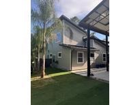 Beautiful side view of gray home with palm trees and nice landscaping at 2325 Audley St, Oviedo, FL 32765