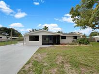 Charming single-story home featuring a screened porch, freshly painted exterior, and landscaped front yard at 2575 King Ave, Auburndale, FL 33823