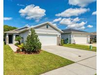 Charming single-story home featuring a well-maintained lawn, a two-car garage, and stone accents at 3028 Lakes Crest Ave, St Cloud, FL 34772