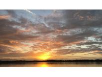 Scenic sunset view over the lake with clouds and reflections of orange and yellow light, Florida at 604 Desoto Dr, Casselberry, FL 32707