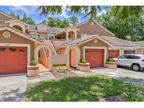Charming multi-Gathering home featuring well-kept lawns and vibrant red garage doors at 7856 Sugar Bend Dr # 7856, Orlando, FL 32819