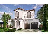 Stunning two-story home featuring a clay tile roof, balcony, arched entry, and a spacious two-car garage at 1473 Berkshire Ave, Winter Park, FL 32789