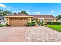 Charming single-story home with a well-maintained front yard, lush landscaping, and a spacious two-car garage at 1709 Kinsman Way, Lakeland, FL 33809