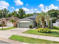Charming single-story home with a well-manicured lawn and mature palm tree in a desirable neighborhood at 1712 Riveredge Rd, Oviedo, FL 32766