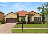 Charming single-story home featuring a well-manicured lawn and eye-catching red tile roof at 212 Lugano Way, Debary, FL 32713