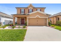 Charming two-story home features a well-manicured lawn, covered entry, and a spacious two-car garage at 2254 Canyon Breeze Ave, Kissimmee, FL 34746